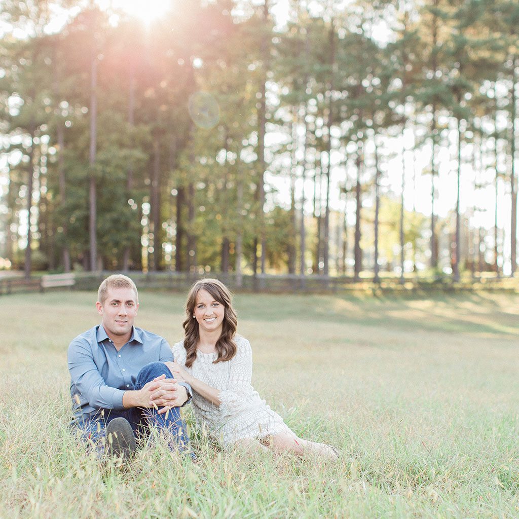 engaged couple in field, pine trees, open field - Finnigan's Run Farm