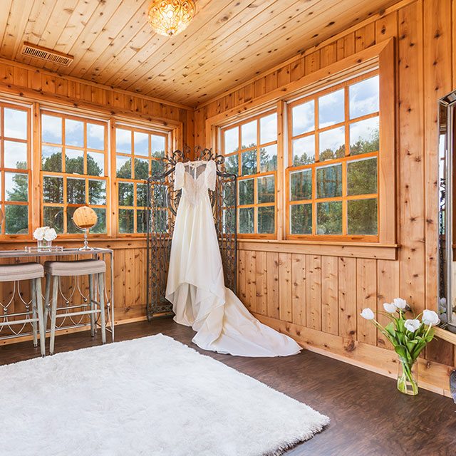 wedding dress hanging out screen in wooden room - Finnigan's Run Farm